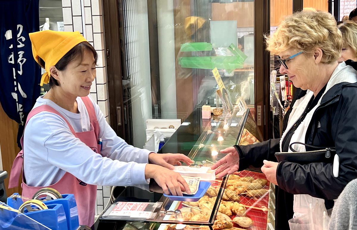 Buying fish sticks from a local vendor. (Pax Global Media)